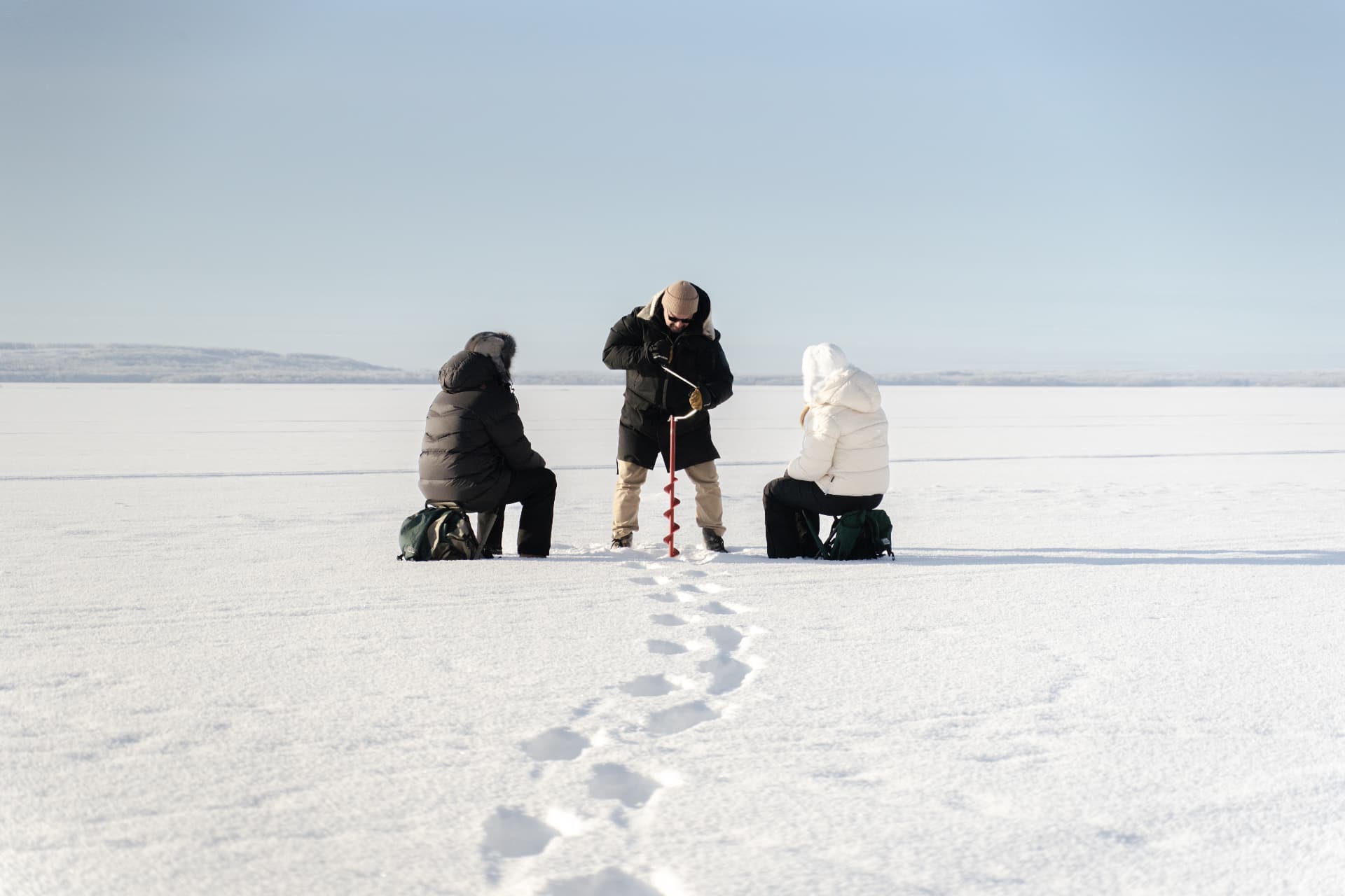 The frozen lake beside the sauna, where the ice hole stays open all winter at Neituri Manor