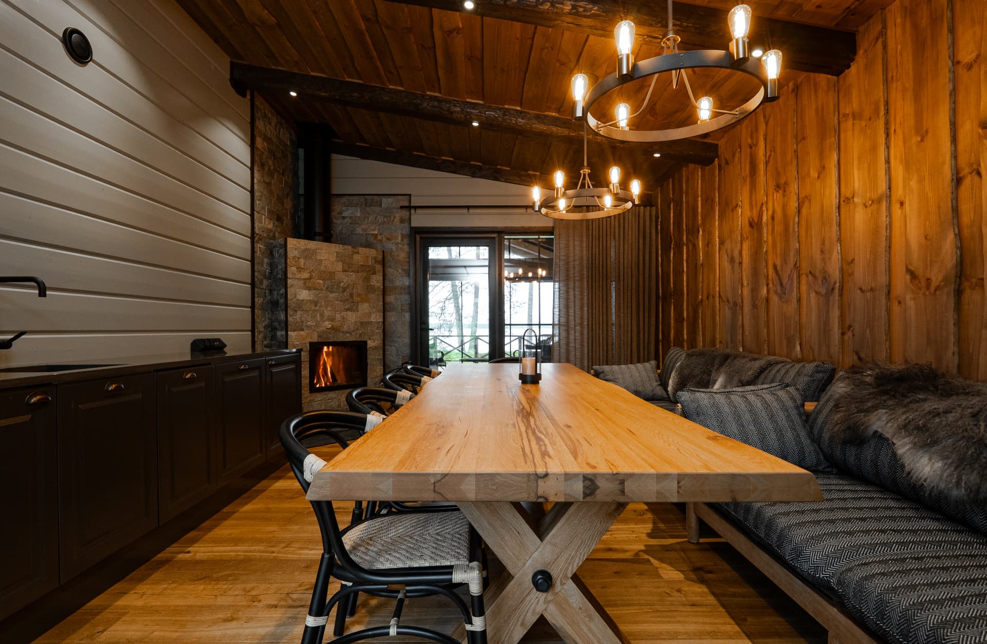Long table in the dining hall with the fire lit, private dining for sixteen at Neituri Manor