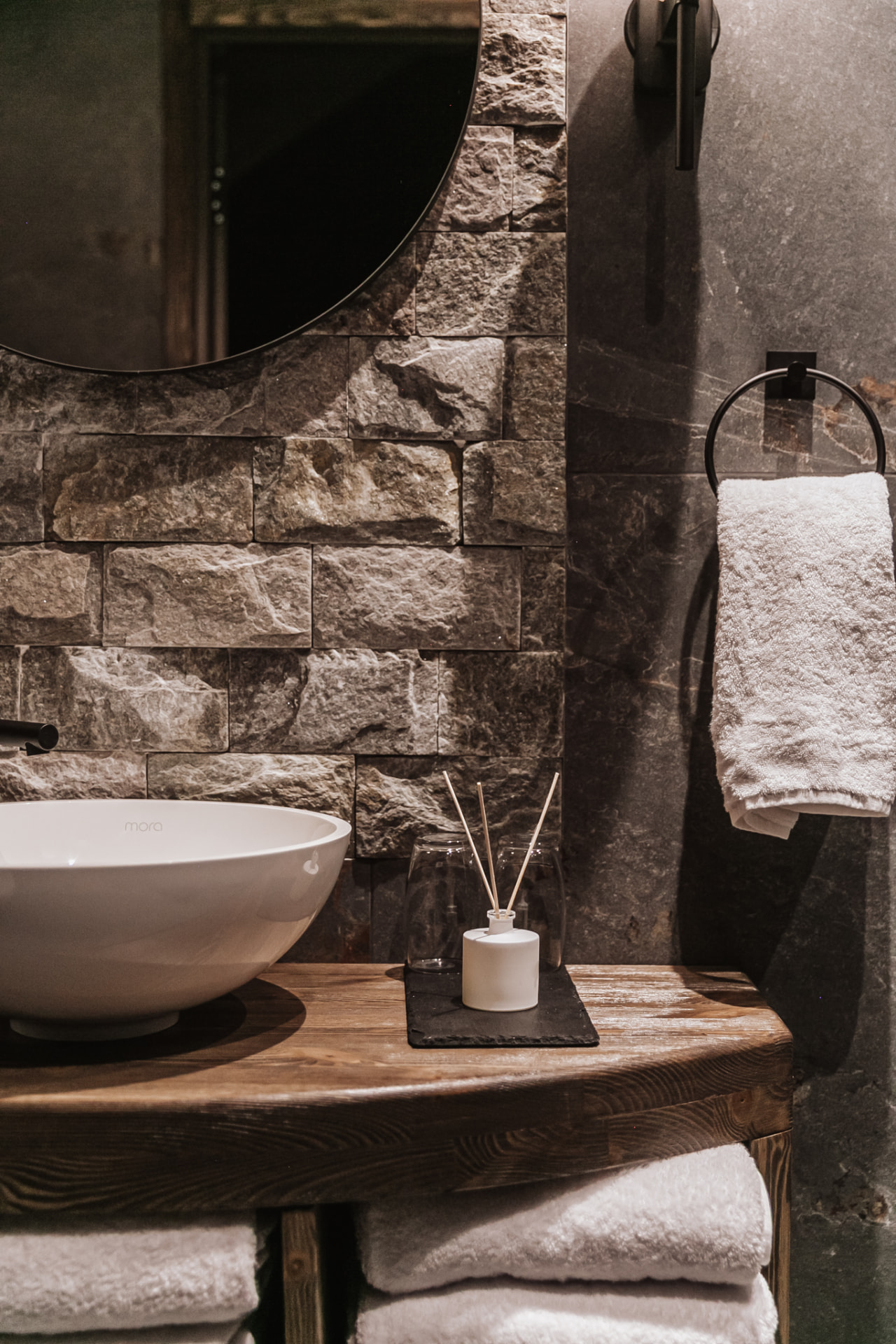 Washroom mirror and stone wall beside the sauna at Neituri Manor, Nordic wellness detail